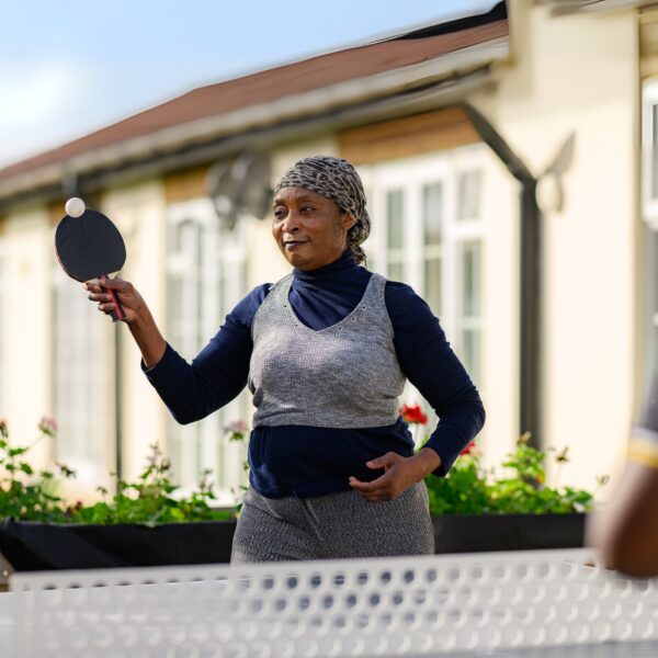 Jane Lewis Support Worker playing table tennis with resident