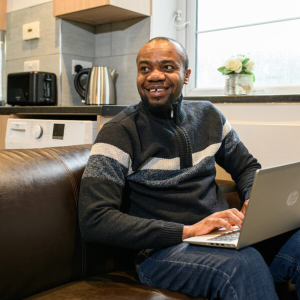 Male carer applying for Jane Lewis job on laptop