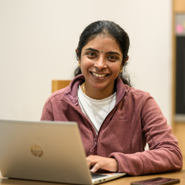 Carer using laptop to apply for a Jane Lewis job