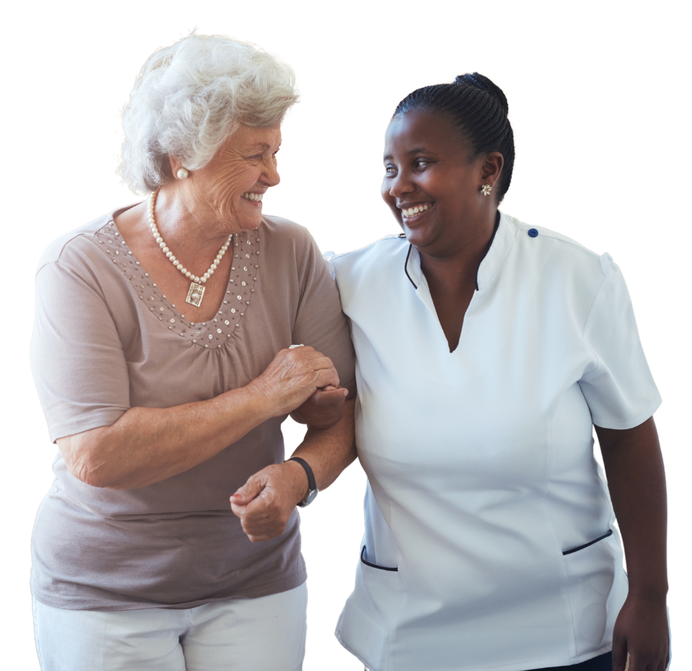 Older woman walking arm in arm with a female carer, smiling in conversation